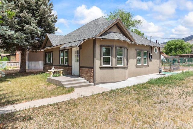 195 S 200 E, Monroe, UT 84754 - view of front facade with stucco siding, a shingled roof, and stone siding