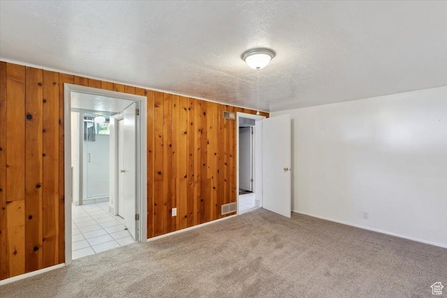 630 Polk Ave, Ogden, UT 84404 - carpeted empty room with wood walls, a textured ceiling, and baseboards