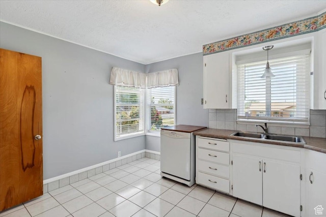 630 Polk Ave, Ogden, UT 84404 - kitchen featuring a sink, dishwasher, white cabinets, backsplash, and baseboards