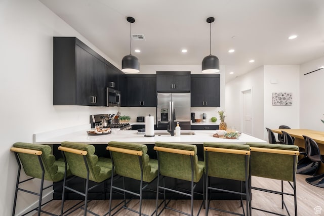 306 E 500 N Unit 34, Hurricane, UT 84737 - kitchen featuring dark cabinets, stainless steel appliances, light countertops, a peninsula, and recessed lighting