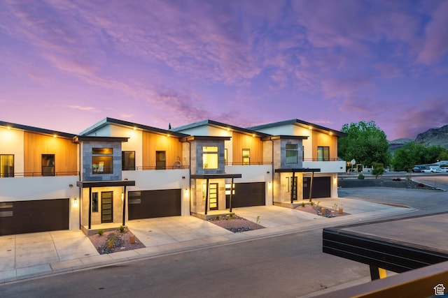 306 E 500 N Unit 34, Hurricane, UT 84737 - view of front facade featuring a balcony, an attached garage, concrete driveway, and stucco siding