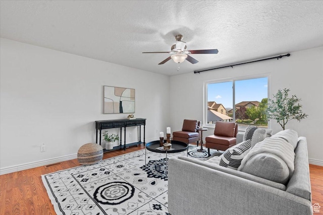 6286 W Anders Ridge Way S, West Valley City, UT 84128 - living room featuring baseboards, ceiling fan, wood finished floors, and a textured ceiling