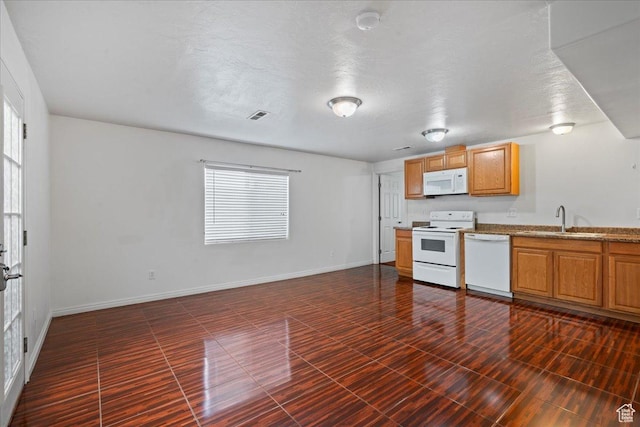 6286 W Anders Ridge Way S, West Valley City, UT 84128 - kitchen with white appliances, a sink, healthy amount of natural light, and baseboards