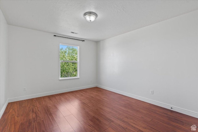 6286 W Anders Ridge Way S, West Valley City, UT 84128 - spare room featuring wood finished floors, baseboards, and a textured ceiling