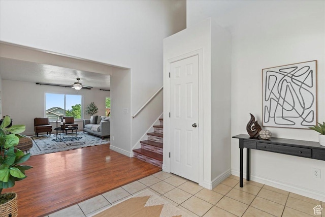 6286 W Anders Ridge Way S, West Valley City, UT 84128 - entrance foyer featuring light tile patterned flooring, stairs, a ceiling fan, and baseboards