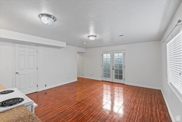 6286 W Anders Ridge Way S, West Valley City, UT 84128 - unfurnished living room with baseboards, french doors, and a textured ceiling