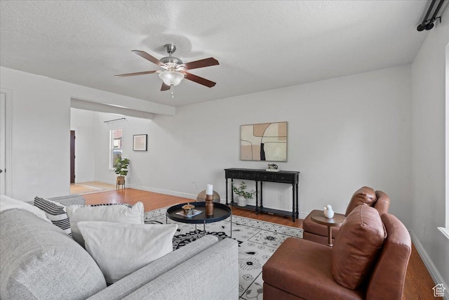 6286 W Anders Ridge Way S, West Valley City, UT 84128 - living area featuring a ceiling fan, wood finished floors, baseboards, and a textured ceiling