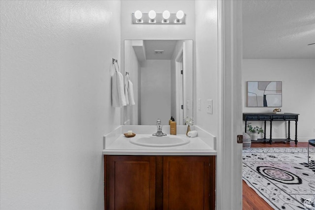 6286 W Anders Ridge Way S, West Valley City, UT 84128 - bathroom featuring vanity, wood finished floors, and a textured ceiling