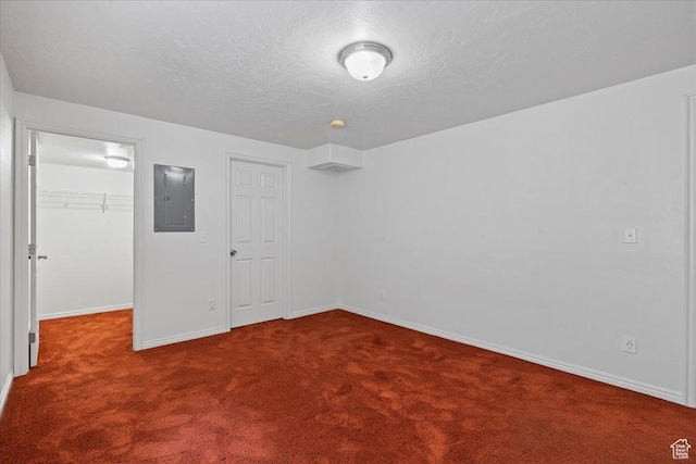 6286 W Anders Ridge Way S, West Valley City, UT 84128 - unfurnished bedroom featuring electric panel, carpet floors, a spacious closet, baseboards, and a textured ceiling