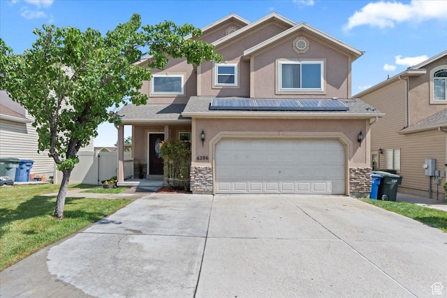 6286 W Anders Ridge Way S, West Valley City, UT 84128 - view of front of home with stucco siding, driveway, an attached garage, and stone siding