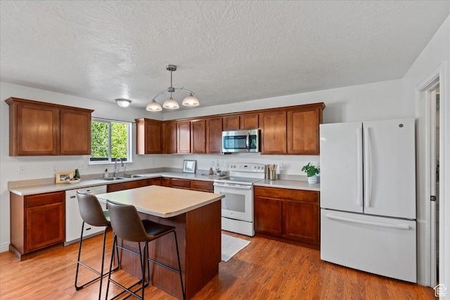 6286 W Anders Ridge Way S, West Valley City, UT 84128 - kitchen with white appliances, a sink, a textured ceiling, light wood-style floors, and light countertops