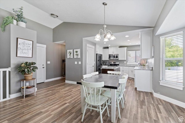 1628 W 1050 S, Syracuse, UT 84075 - dining area with wood finished floors, a chandelier, baseboards, and high vaulted ceiling