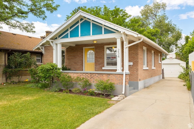 234 W 500 S, Provo, UT 84601 - view of front of home with an outbuilding, a front yard, brick siding, and a garage
