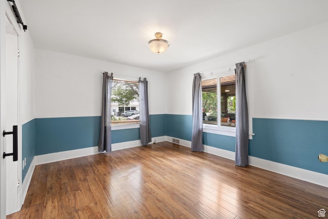 234 W 500 S, Provo, UT 84601 - unfurnished room featuring a barn door, wood finished floors, and baseboards