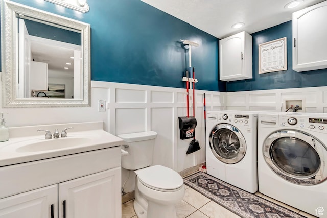 10453 S 2775th St W, South Jordan, UT 84095 - bathroom with washing machine and dryer, a decorative wall, toilet, vanity, and wainscoting