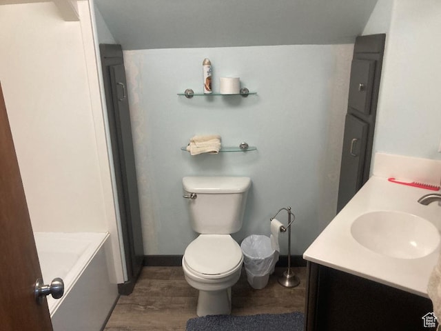 3480 S 4000th Rd W, Delta, UT 84624 - full bathroom with double vanity, a tub, wood finished floors, toilet, and baseboards