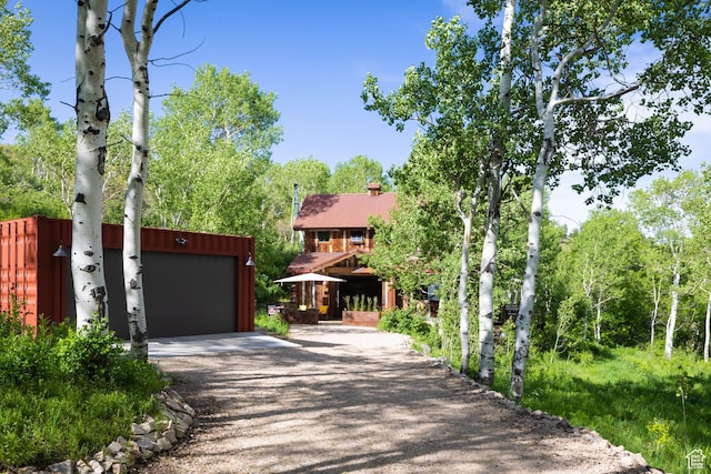 10754 Basin Canyon Rd, Park City, UT 84098 - view of front of house featuring gravel driveway and a chimney