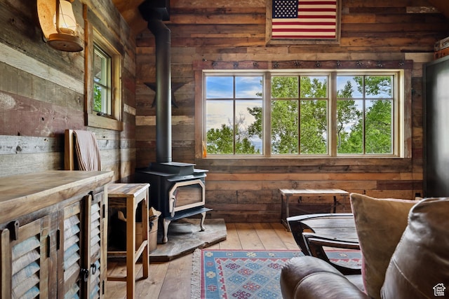 10754 Basin Canyon Rd, Park City, UT 84098 - living area featuring a wood stove, wood walls, plenty of natural light, and wood-type flooring