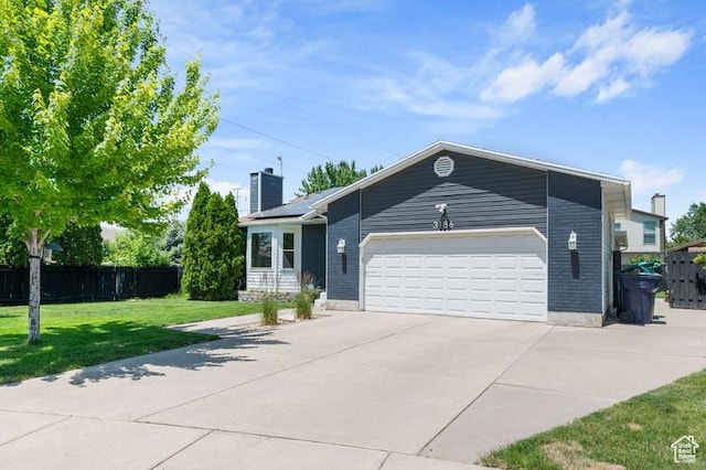3186 W 5925 S, Roy, UT 84067 - view of front of property with a chimney, an attached garage, and driveway
