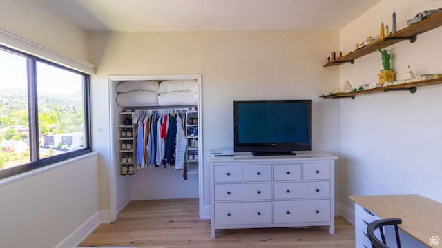 241 N Vine St Unit 1E, Salt Lake City, UT 84103 - bedroom with light wood finished floors, a closet, and baseboards