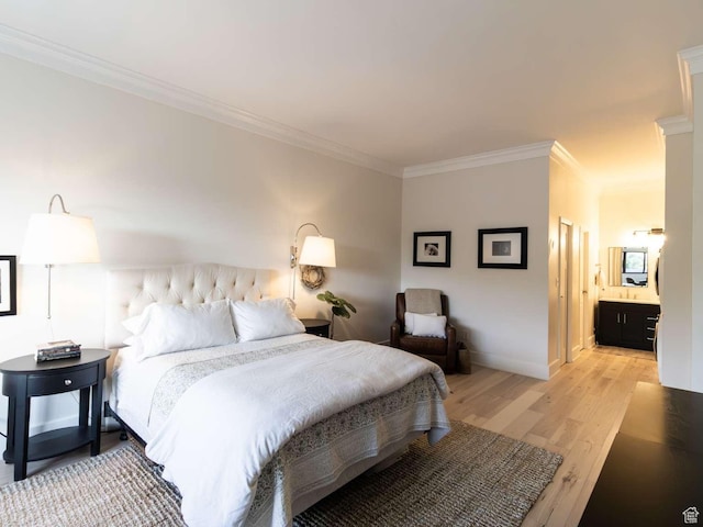 241 N Vine St Unit 1E, Salt Lake City, UT 84103 - bedroom with crown molding, light wood-style flooring, baseboards, and ensuite bath