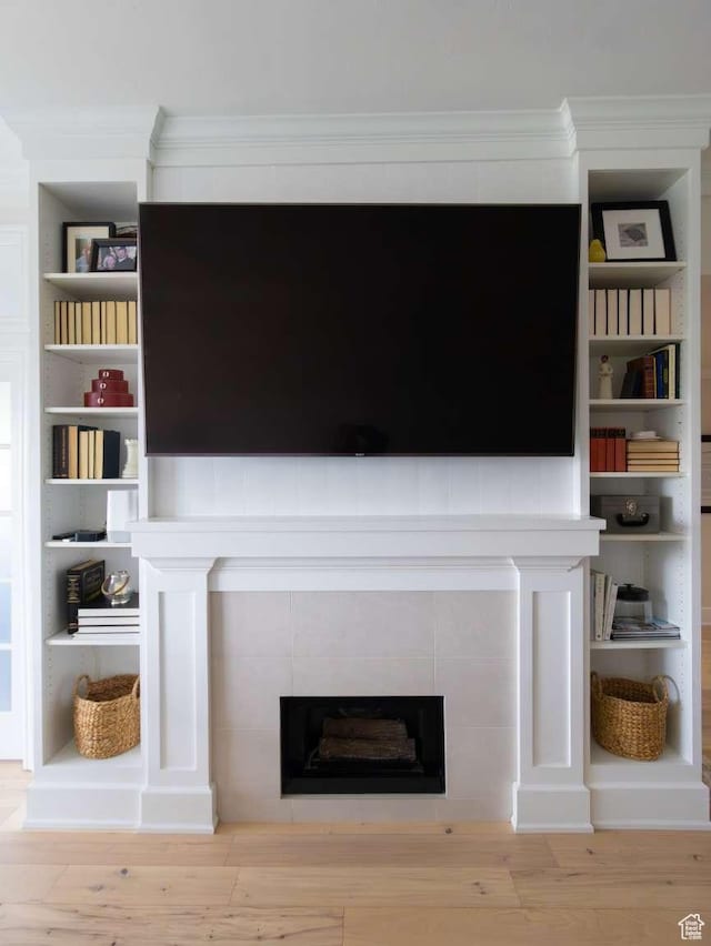 241 N Vine St Unit 1E, Salt Lake City, UT 84103 - detailed view of a tiled fireplace, wood finished floors, and crown molding