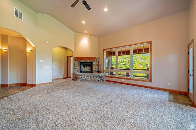 1273 W Lime Canyon Way, Midway, UT 84049 - unfurnished living room with a ceiling fan, a stone fireplace, baseboards, carpet floors, and high vaulted ceiling