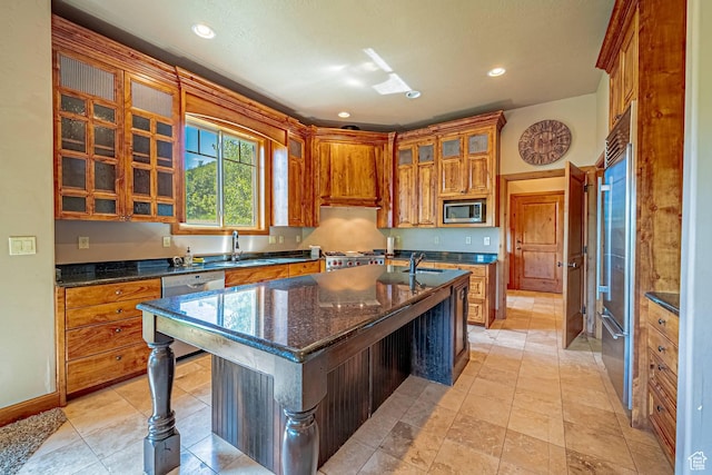 1273 W Lime Canyon Way, Midway, UT 84049 - kitchen featuring appliances with stainless steel finishes, a center island with sink, a sink, brown cabinets, and glass insert cabinets