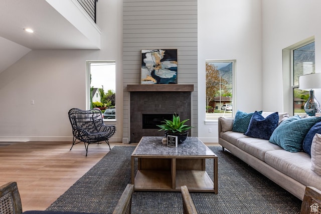 1792 N Siena Cir Unit 13, Pleasant Grove, UT 84062 - living area featuring wood finished floors, a large fireplace, baseboards, vaulted ceiling, and recessed lighting