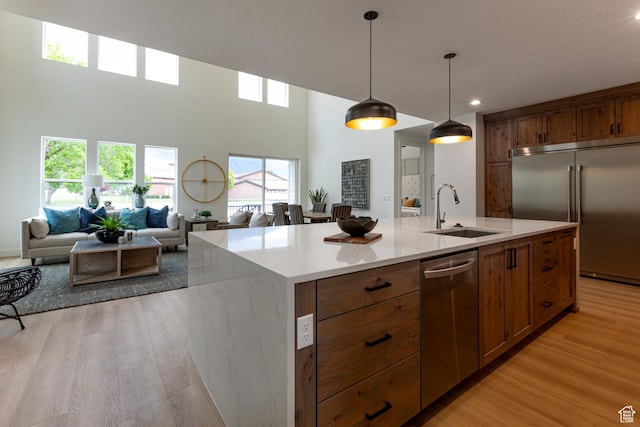 1792 N Siena Cir Unit 13, Pleasant Grove, UT 84062 - kitchen with a sink, stainless steel appliances, open floor plan, light wood-style flooring, and recessed lighting