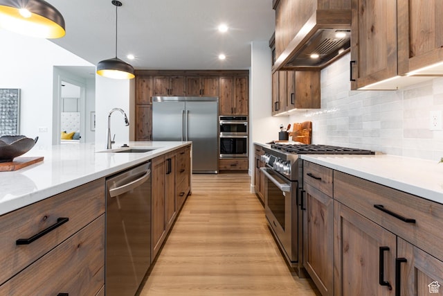 1792 N Siena Cir Unit 13, Pleasant Grove, UT 84062 - kitchen featuring premium appliances, a sink, custom exhaust hood, light wood finished floors, and tasteful backsplash