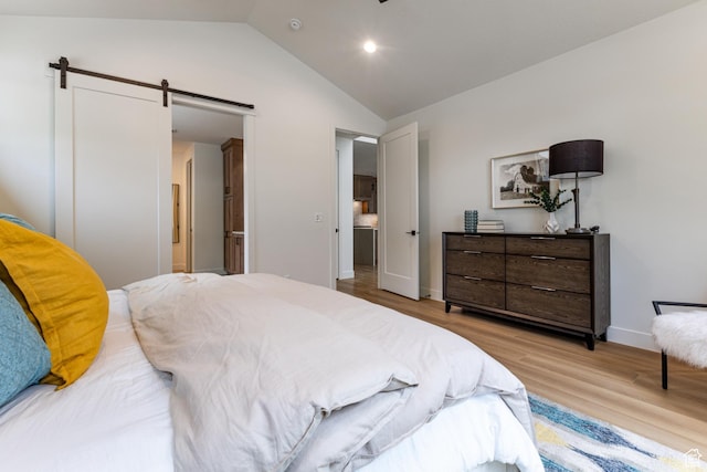 1792 N Siena Cir Unit 13, Pleasant Grove, UT 84062 - bedroom featuring light wood-style flooring, vaulted ceiling, a barn door, baseboards, and recessed lighting