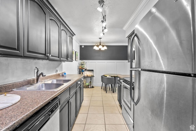 66 W Lester Ave Unit K27, Murray, UT 84107 - kitchen with stainless steel appliances, a sink, rail lighting, light tile patterned floors, and wainscoting