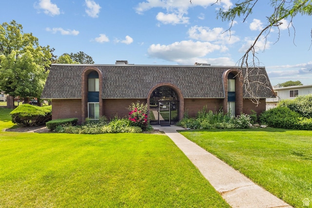 66 W Lester Ave Unit K27, Murray, UT 84107 - view of front of home with mansard roof, brick siding, and a shingled roof