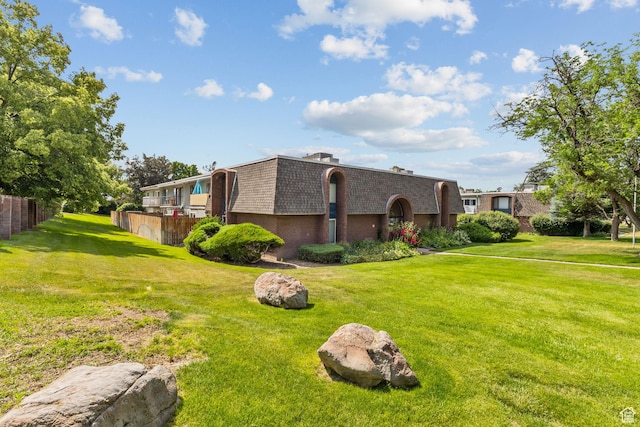 66 W Lester Ave Unit K27, Murray, UT 84107 - view of front facade featuring mansard roof, brick siding, and a shingled roof