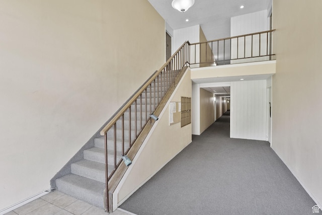 66 W Lester Ave Unit K27, Murray, UT 84107 - staircase featuring a towering ceiling and carpet