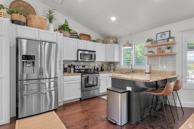 1677 N 2640 W, Lehi, UT 84043 - kitchen with stainless steel appliances, tasteful backsplash, a peninsula, white cabinets, and healthy amount of natural light