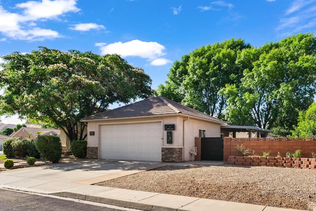 114 E Canterwood Dr, Washington, UT 84780 - view of side of property with stone siding, a garage, driveway, a gate, and stucco siding