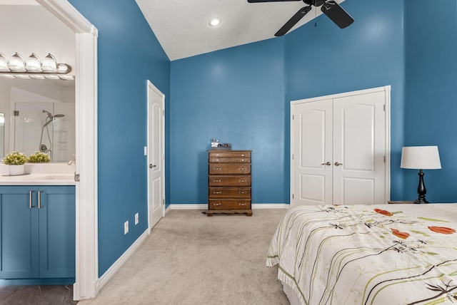 114 E Canterwood Dr, Washington, UT 84780 - bedroom featuring light carpet, baseboards, a closet, ensuite bath, and a sink
