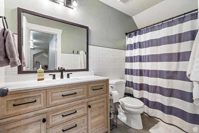 580 N Cherry Ridge Ln, Richmond, UT 84333 - full bathroom featuring tile walls, toilet, vanity, lofted ceiling, and a shower with shower curtain