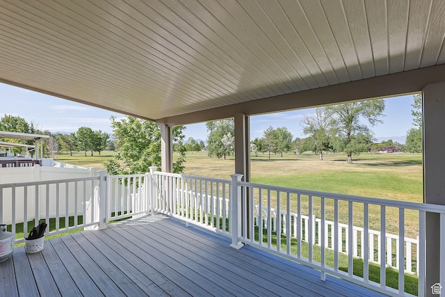 18 Clubhouse Dr, Stansbury Park, UT 84074 - wooden terrace with a lawn and view of wooded area