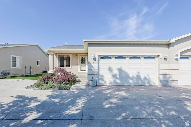 18 Clubhouse Dr, Stansbury Park, UT 84074 - ranch-style house with a garage, driveway, and stucco siding