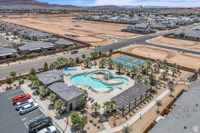 2667 E Wake Ln, St George, UT 84790 - aerial perspective of suburban area featuring a pool area and a mountain backdrop