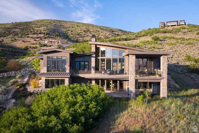 1703 N Chimney Rock Rd Unit 532, Heber City, UT 84032 - back of property featuring stone siding, a chimney, and a mountain view