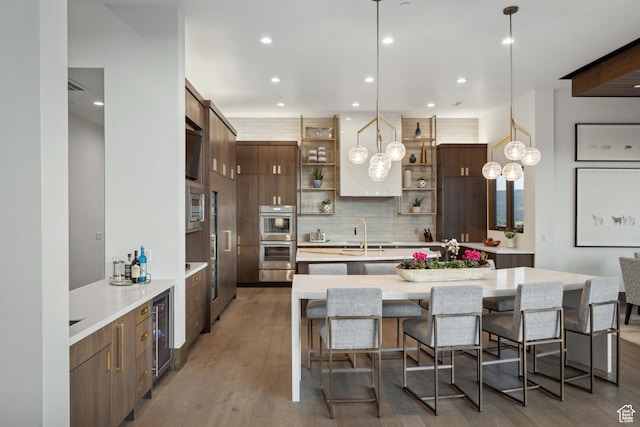 1703 N Chimney Rock Rd Unit 532, Heber City, UT 84032 - kitchen with open shelves, stainless steel appliances, decorative backsplash, wine cooler, and light countertops