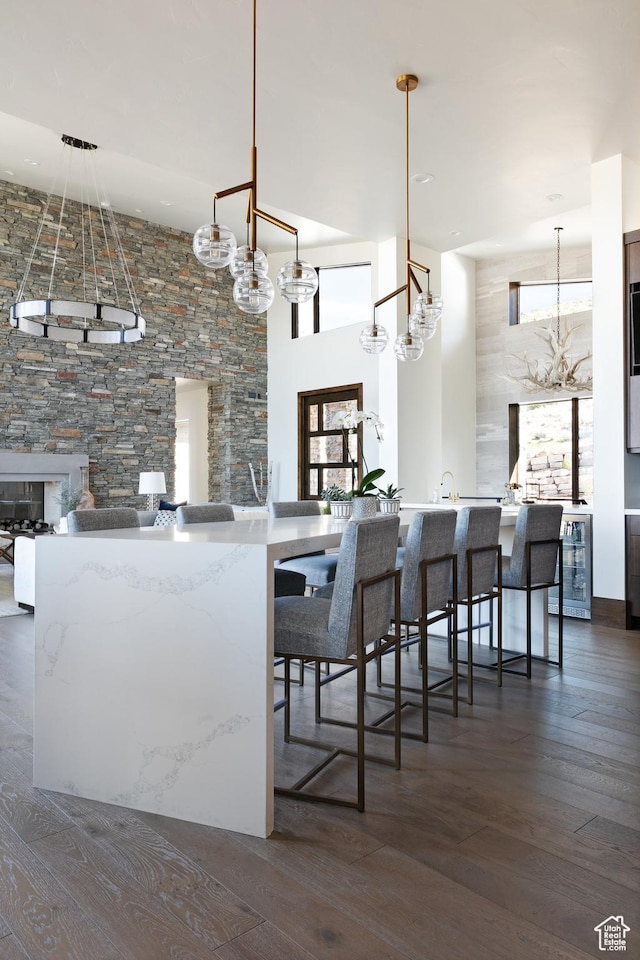 1703 N Chimney Rock Rd Unit 532, Heber City, UT 84032 - kitchen featuring a chandelier, dark wood-style floors, beverage cooler, a high ceiling, and a sink