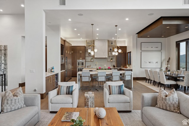 1703 N Chimney Rock Rd Unit 532, Heber City, UT 84032 - living area featuring light wood finished floors, recessed lighting, wine cooler, and a chandelier