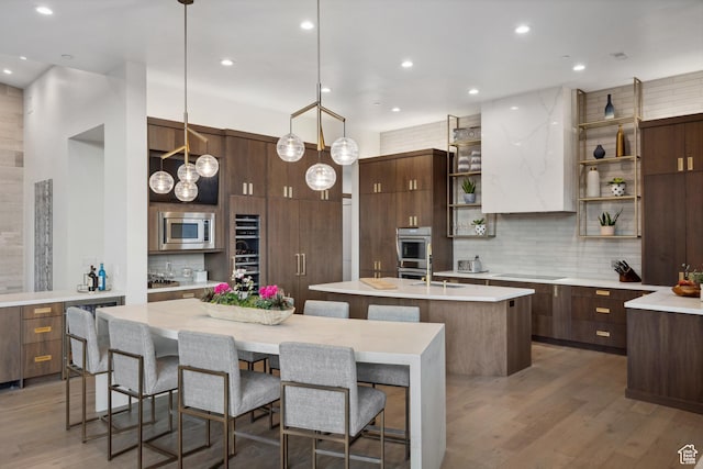 1703 N Chimney Rock Rd Unit 532, Heber City, UT 84032 - kitchen featuring open shelves, a center island with sink, decorative backsplash, appliances with stainless steel finishes, and wood finished floors