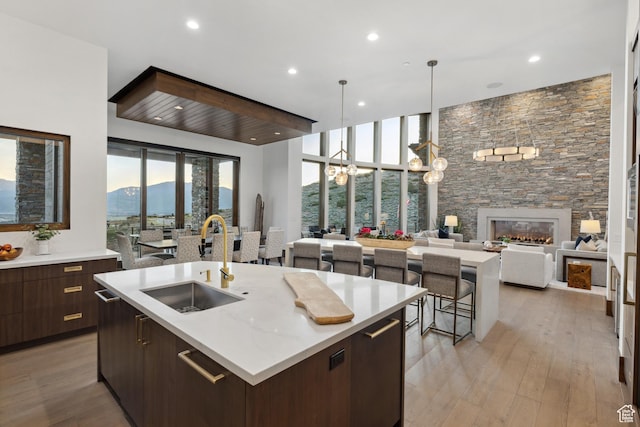 1703 N Chimney Rock Rd Unit 532, Heber City, UT 84032 - kitchen with a sink, modern cabinets, open floor plan, a kitchen island with sink, and light countertops