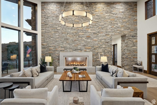1703 N Chimney Rock Rd Unit 532, Heber City, UT 84032 - living room with wood finished floors, a towering ceiling, and a lit fireplace